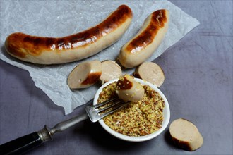 Sliced bratwurst and skin with Dijon mustard