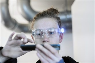 Young logistician working with scan glasses