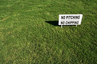 No pitching or chipping sign on lush green grass