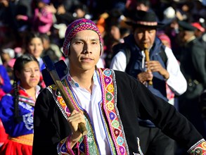 Portrait of an indigenous man in traditional traditional costume during a parade on the eve of Inti Raymi