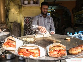 Vendor prepares tasty snacks at a street kitchen