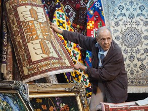 Carpet dealer presents carpets in Vakil Bazaar