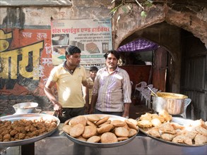 Vendors offer snacks at a street food stall