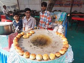 Vendors present tasty fried snacks at a street food stall