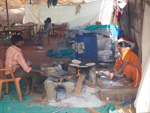 Vendors prepare flatbread at a street kitchen