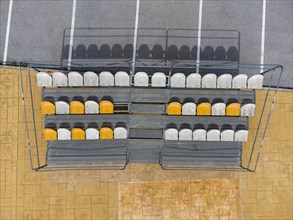 Aerial view of small stands next to parking lot with seats for spectators at a fooball pitch in Altea La Vella