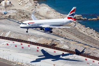 A British Airways Airbus A320 with the registration G-EUYS lands at Gibraltar Airport