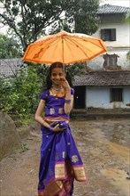 A girl standing in front of 150 years old perumangattu mana