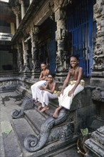 Three Dikshit boys sitting on the steps in Nataraja temple