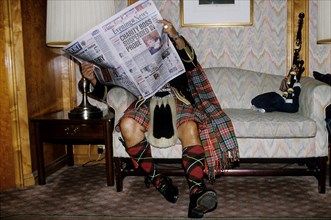 Scotsman reading newspaper