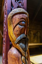 Wooden sculptures in a reconstructed long house in the Lofotr Viking Museum