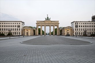 Brandenburg Gate with empty Pariser Platz in the early morning