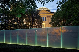 Memorial to the Sinti and Roma of Europe murdered under National Socialism with the Reichstag illuminated in the evening