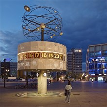 Urania world time clock on Alexanderplatz in the evening