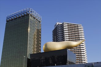 Asahi Breweries headquarters building with the Asahi Flame by french designer Philippe Starck on the east bank of the Sumida River in Sumida district
