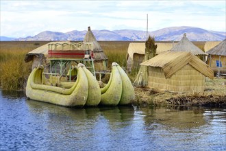 Typical reed boats and reed huts on a floating island of the Uro