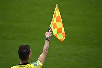 Linesman indicates offside position with flag