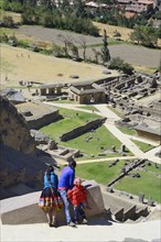 Three indigenous children in the Inca ruins