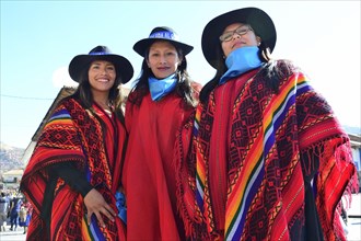 Three young indigenous woman in Ponchos