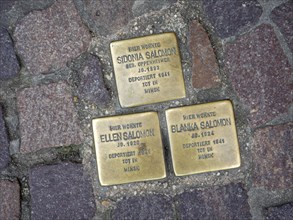 Stumbling stones with names of deported Jews between paving stones