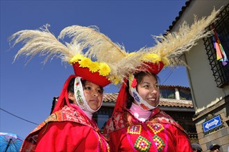 Two indigenous woman in traditional traditional costume with headdress