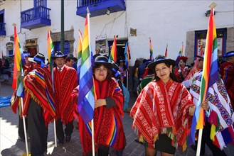 Group with flags in ponchos in the old town