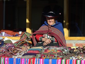 Indigenous old woman in traditional traditional costume in a souvenir cooperative