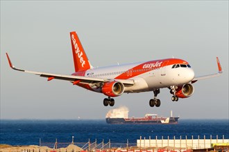 An Easyjet Airbus A320 with the registration G-EZOM lands at Gibraltar Airport
