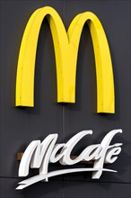 Logo of the fast food chain McDonald's with McCafe at a restaurant