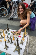 Girl buys Eiffel Tower model as souvenir