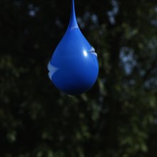 Exploding blue balloon with water inside