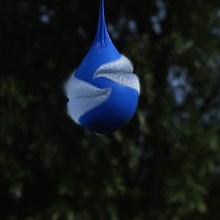 Exploding blue balloon with water inside