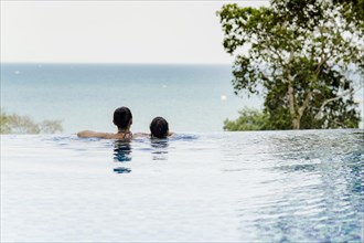 Mother and daughter by the pool