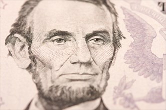 Abstract macro of U.S. five dollar bill's abraham lincoln face with narrow depth of field