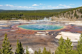 Steaming hot spring with colored mineral deposits and turquoise water