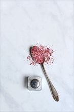 Rose salt in spoon and salt shaker