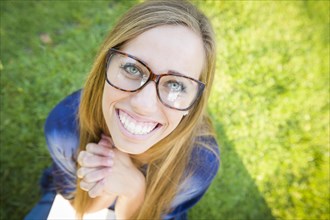 Fun wide angle portrait of pretty young woman at the park