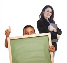 Hispanic boy with thumbs up holding blank chalk board and teacher behind isolated on white