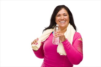 Attractive middle aged hispanic woman in workout clothes with water bottle and towel against a white background