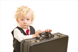 Cute boy in vest suit and tie with briefcase on white