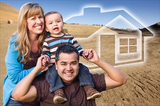 Happy hopeful mixed-race family at construction site with ghosted house behind