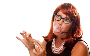 Red haired retro receptionist blowing a bubble isolated on a white background