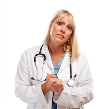 Concerned female blonde doctor or nurse with hands folded isolated on a white background