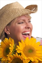 Attractive blond with cowboy hat and sunflower isolated on a white background