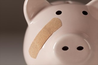 Piggy bank with bandage on face