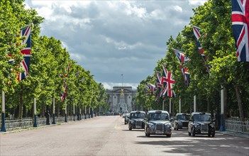 London taxis on the street The Mall with lined up Great Britain flags