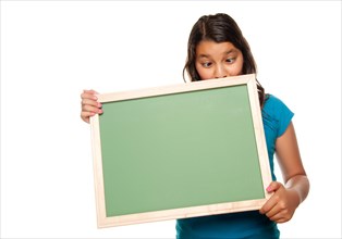 Pretty crosseyed hispanic girl holding blank chalkboard isolated on a white background
