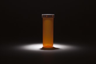Empty medicine bottle under spot light abstract