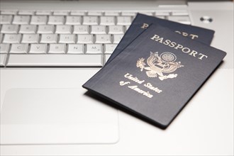 Abstract of two passports on a laptop computer keyboard
