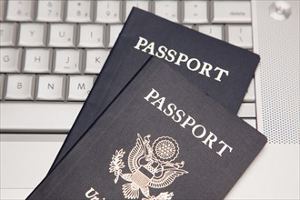 Abstract of two passports on a laptop computer keyboard